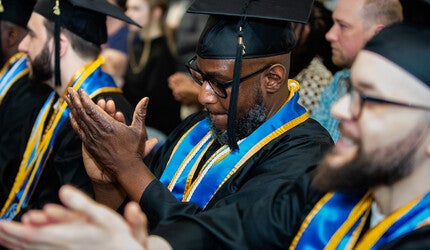 Yale Prison Education Initiative graduate applauding at the ceremony