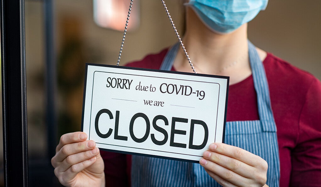 A small business owner closing their shop due to COVID-19