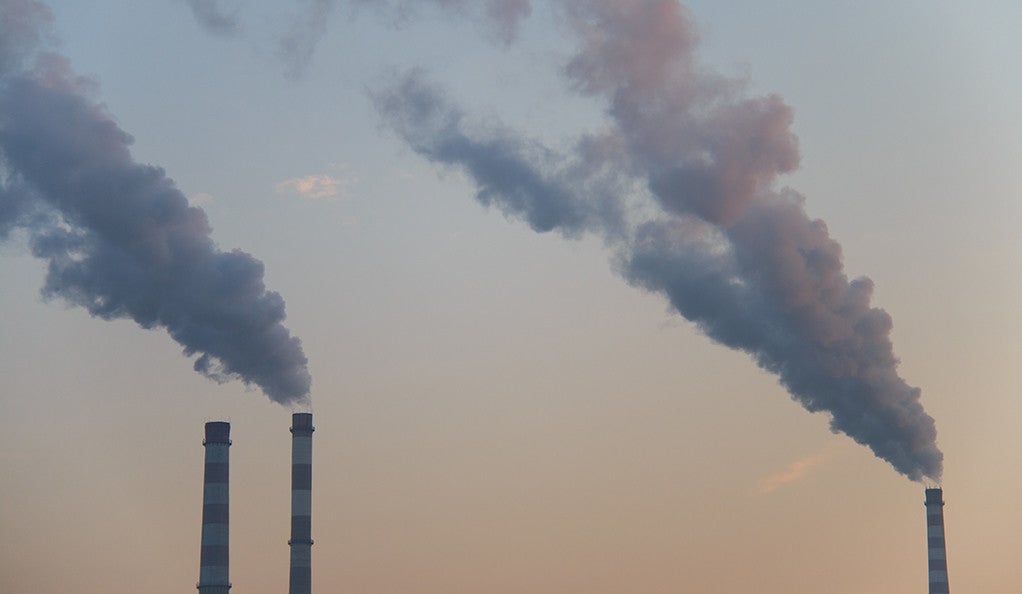 A trio of smokestacks emitting air pollution.
