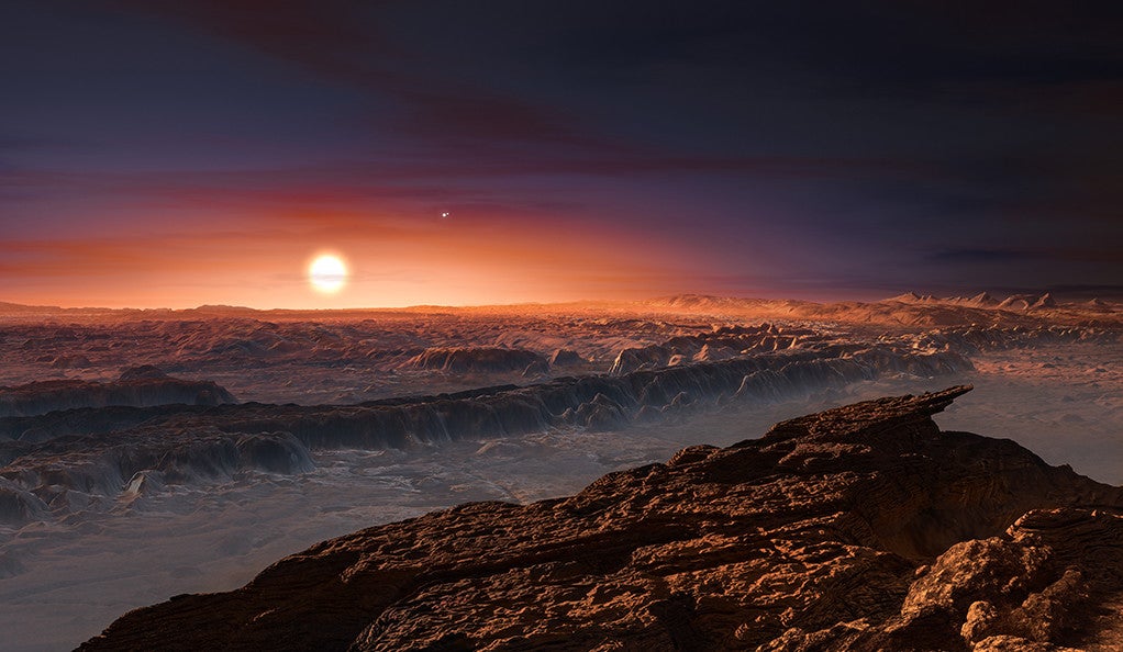 This artist’s impression shows a view of the surface of the planet Proxima b orbiting the red dwarf star Proxima Centauri
