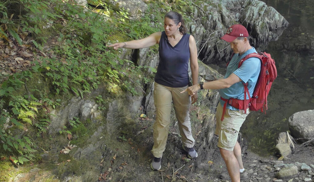 Maureen Long and Ethan Baxter visit an outcrop of the metamorphic rock schist in Massachusetts