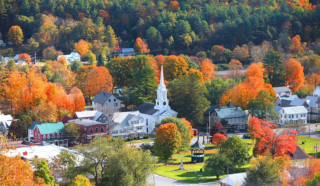 An aerial view of a small New England town in autumn.