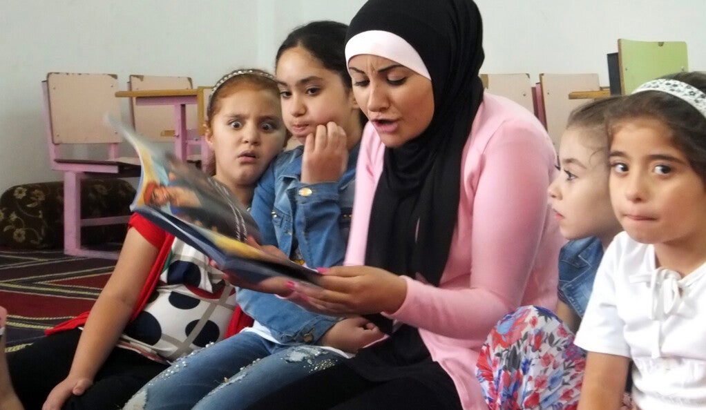  A We Love Reading ambassador reads aloud to children in a mosque in Karak, Jordan.