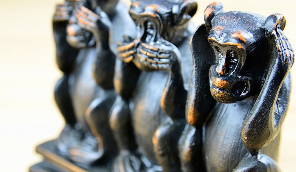 A closeup photo of a Three Wise Monkeys statuette. 