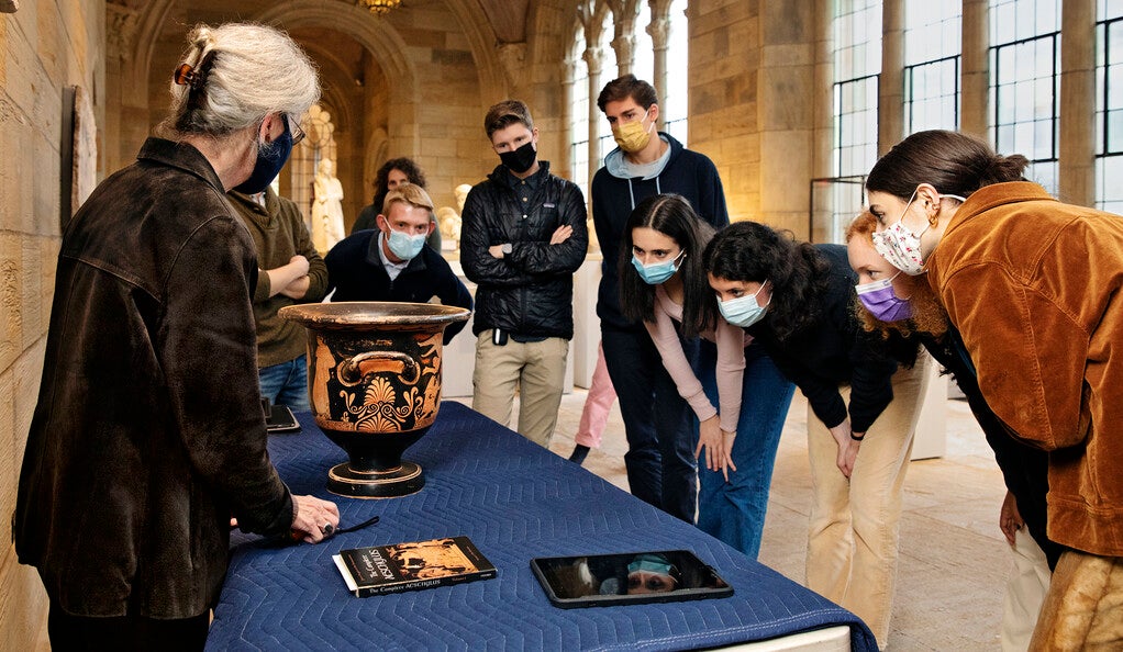Students examining an ancient bell krater.