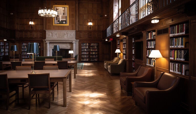 Leather chairs and reading tables with lamps inside the Linonia and Brothers reading room