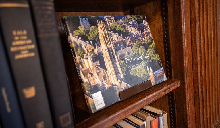 A copy of the book “Picturing Yale” on a book shelf