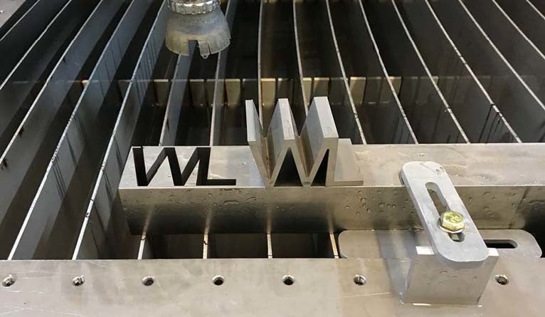 A demonstration piece on the cutting bed of the water jet cutter.