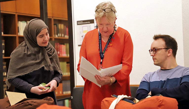 Hatice Sak, Roberta Dougherty, and Marshall Watson confer during a class session at the Beinecke Library