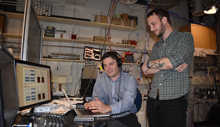 Spencer Topel and Kyle Serniak in the quantum labs in Becton Center listening to the first sound the quantum computer made