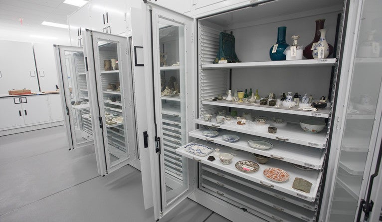 Storage unit with shelves extended to show objects being stored