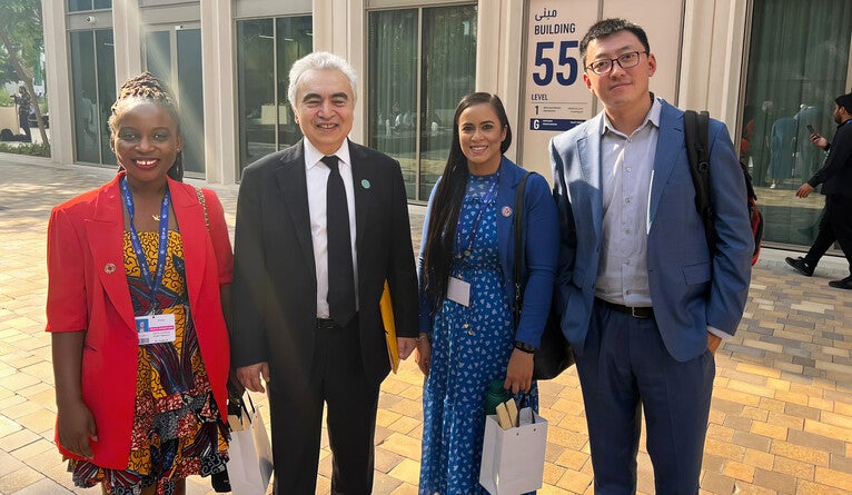 Doris Agbevivi, Cassandra Dewan, and Sean Zhang with Fatih Birol, the executive director of the International Energy Agency.