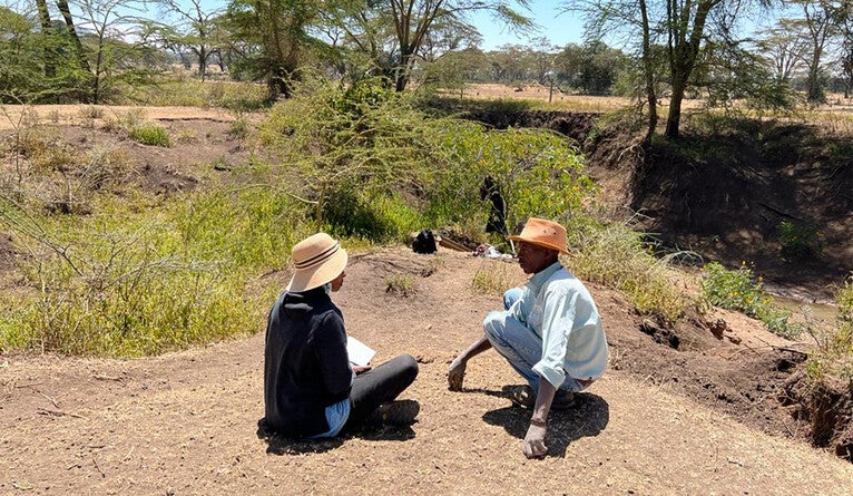 Waweru interviewing a local who discovered fossils from an extinct buffalo species.
