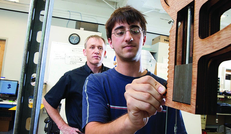 Brink working on his senior project in 2011. Brink created a 15-key device that could be adjusted to mimic various carillons.